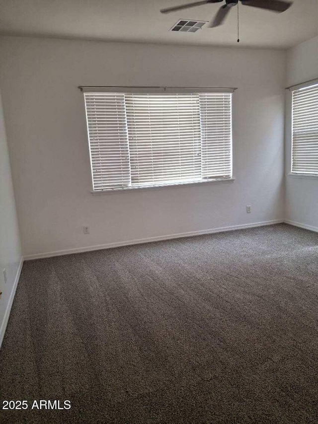 spare room featuring visible vents, ceiling fan, carpet, and baseboards