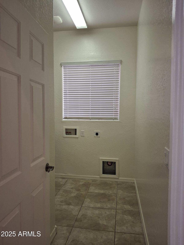 laundry area featuring laundry area, tile patterned floors, hookup for an electric dryer, washer hookup, and baseboards