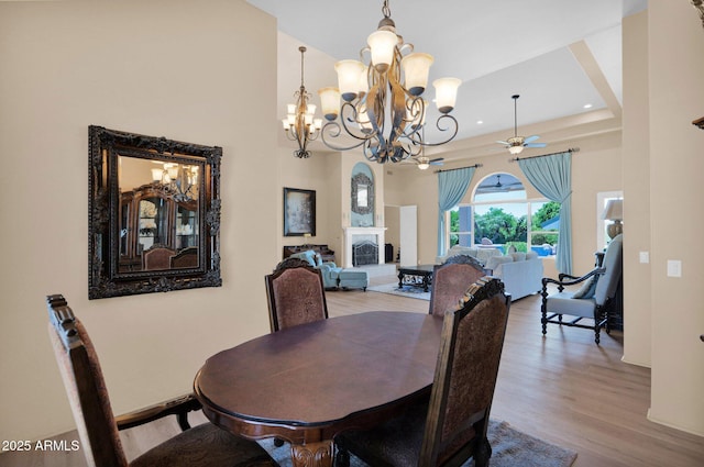 1940 N Stevens Cir, Mesa, AZ 85205 - dining area featuring a chandelier, wood finished floors, ceiling fan, recessed lighting, and a towering ceiling