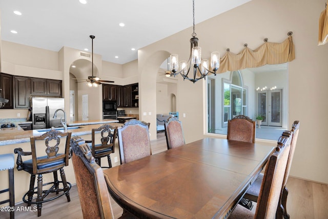 1940 N Stevens Cir, Mesa, AZ 85205 - dining area featuring arched walkways, a chandelier, light wood-style flooring, a ceiling fan, and recessed lighting
