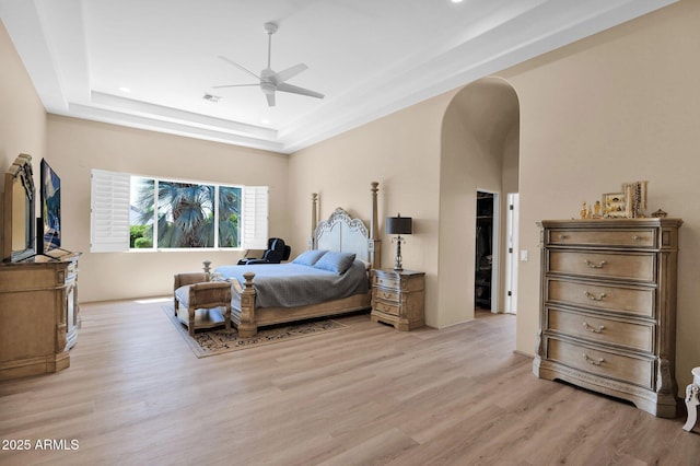 1940 N Stevens Cir, Mesa, AZ 85205 - bedroom featuring a raised ceiling, arched walkways, light wood-style flooring, recessed lighting, and ceiling fan