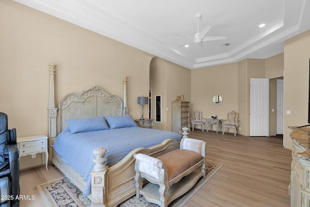 1940 N Stevens Cir, Mesa, AZ 85205 - bedroom with light wood-type flooring, a tray ceiling, ceiling fan, and recessed lighting