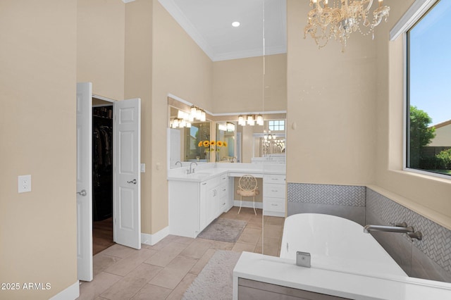 1940 N Stevens Cir, Mesa, AZ 85205 - bathroom featuring a soaking tub, vanity, a chandelier, healthy amount of natural light, and ornamental molding