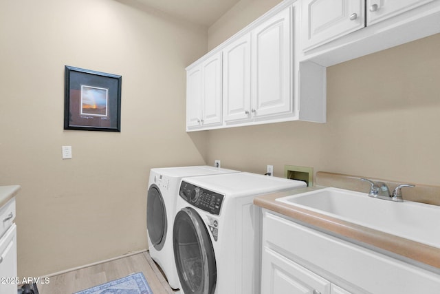 1940 N Stevens Cir, Mesa, AZ 85205 - laundry area featuring cabinet space, washer and dryer, and light wood-type flooring