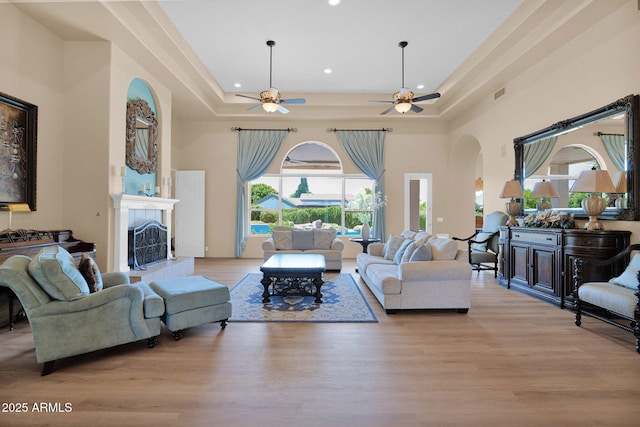 1940 N Stevens Cir, Mesa, AZ 85205 - living room with arched walkways, plenty of natural light, a ceiling fan, wood finished floors, and recessed lighting