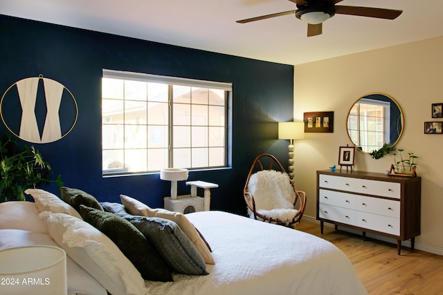 bedroom with ceiling fan and light hardwood / wood-style flooring