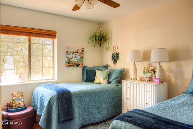 bedroom featuring multiple windows and ceiling fan