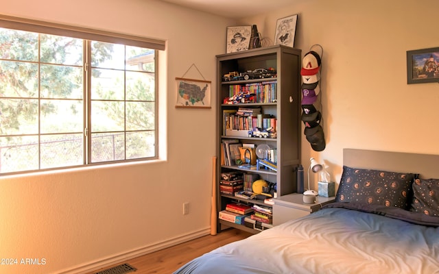 bedroom with hardwood / wood-style flooring