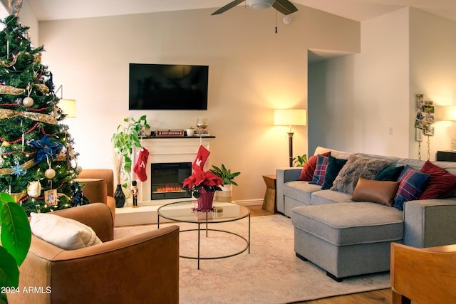 living room featuring light wood-type flooring, ceiling fan, and lofted ceiling