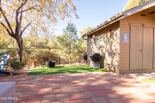 view of patio / terrace with a shed