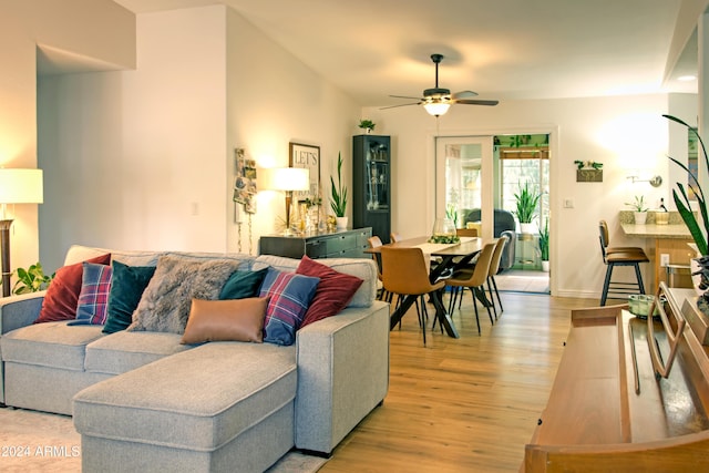 living room featuring ceiling fan and light wood-type flooring