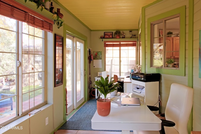 dining area with light tile patterned floors and ornamental molding