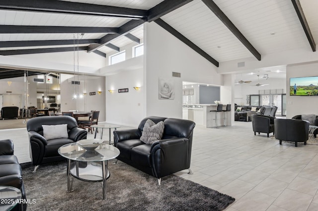 living room featuring beamed ceiling, light tile patterned flooring, and high vaulted ceiling