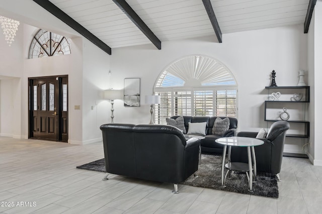 living room with beam ceiling and high vaulted ceiling