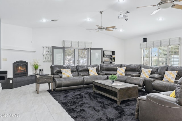 living room featuring light tile patterned flooring, lofted ceiling, and ceiling fan