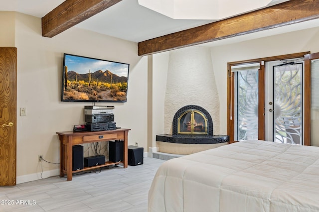 bedroom with access to outside, a fireplace, and beam ceiling