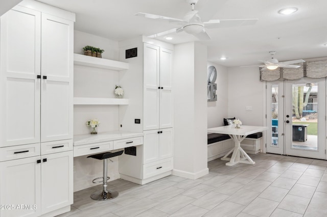 interior space with ceiling fan