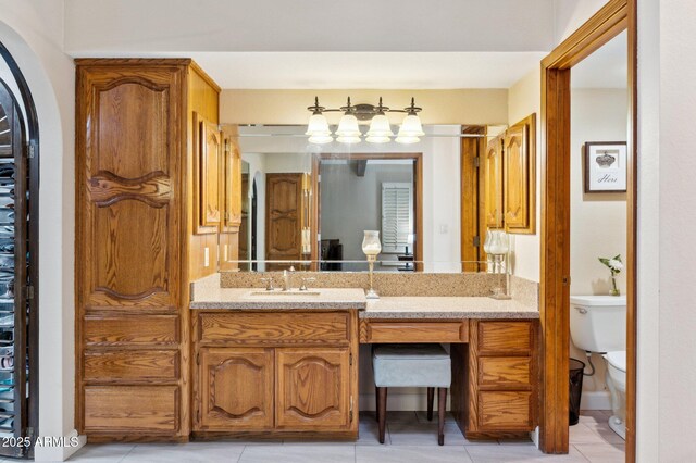 bathroom featuring vanity, tile patterned floors, and toilet