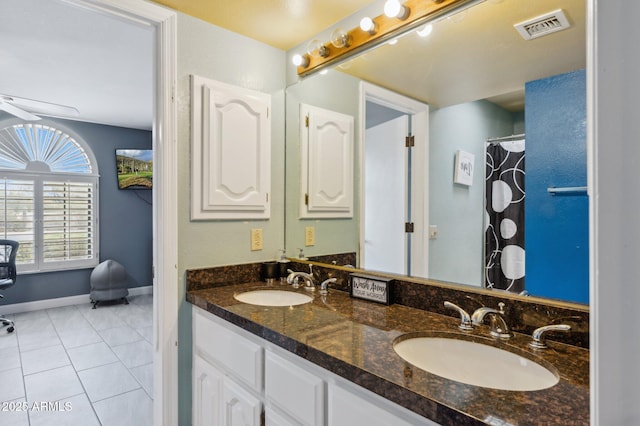 bathroom with tile patterned flooring and vanity