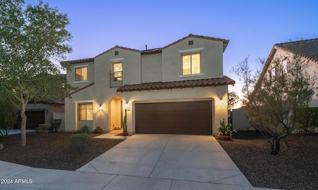 mediterranean / spanish home featuring a garage