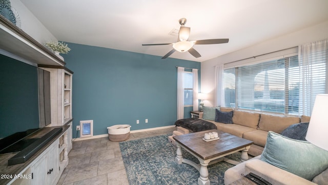 living room featuring ceiling fan and light tile patterned flooring