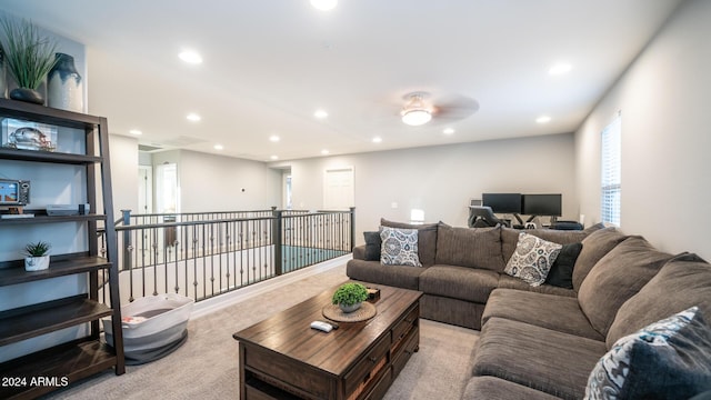 carpeted living room with ceiling fan