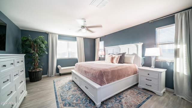 bedroom with ceiling fan and light wood-type flooring