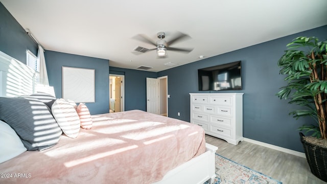 bedroom with light hardwood / wood-style floors and ceiling fan