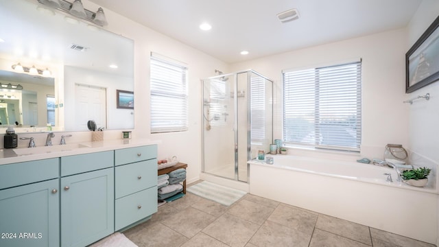 bathroom with tile patterned floors, vanity, and separate shower and tub