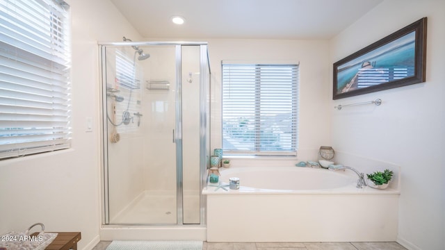 bathroom with shower with separate bathtub and tile patterned floors