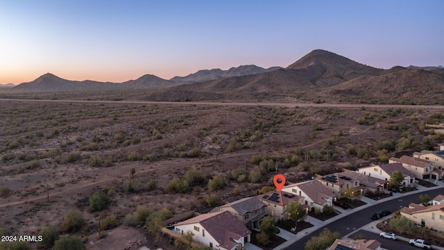 aerial view at dusk featuring a mountain view