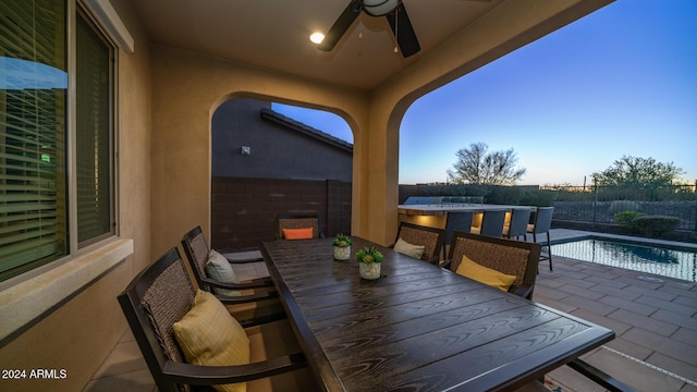 view of patio / terrace featuring a fenced in pool and ceiling fan