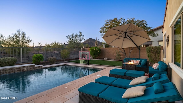 view of swimming pool with a fire pit