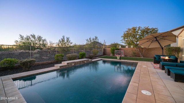 view of pool at dusk