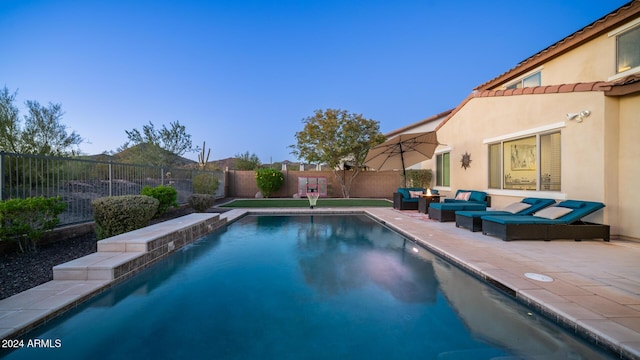 view of swimming pool with a patio