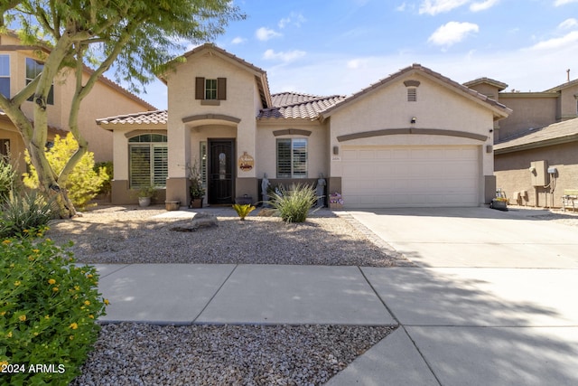 mediterranean / spanish-style house featuring a garage