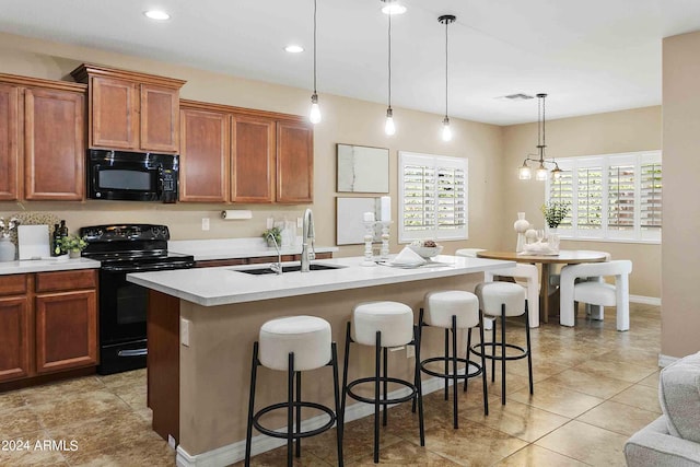 2736 E Sourwood Dr, Gilbert, AZ 85298 - kitchen featuring black appliances, a sink, light countertops, a kitchen bar, and a kitchen island with sink
