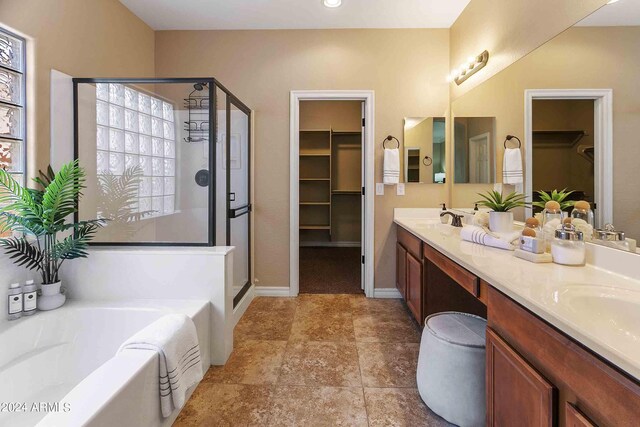 2736 E Sourwood Dr, Gilbert, AZ 85298 - full bath with a stall shower, a walk in closet, a garden tub, double vanity, and baseboards