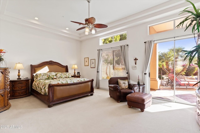 bedroom featuring a raised ceiling, light carpet, access to exterior, and ceiling fan