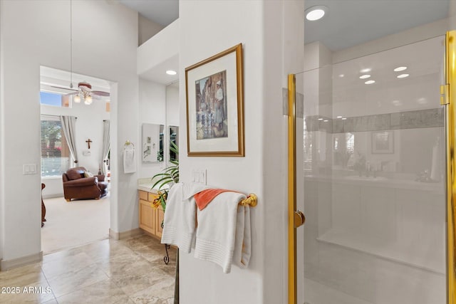 bathroom with an enclosed shower, vanity, and ceiling fan