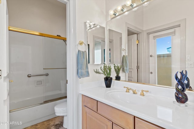 full bathroom with vanity, enclosed tub / shower combo, and toilet