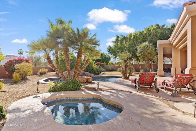 view of swimming pool featuring a hot tub and a patio