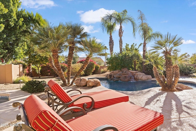 view of patio / terrace with a fenced in pool and pool water feature