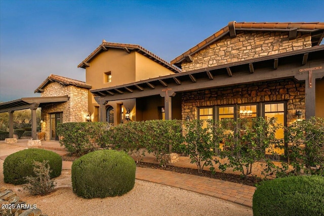 exterior space with stone siding and stucco siding