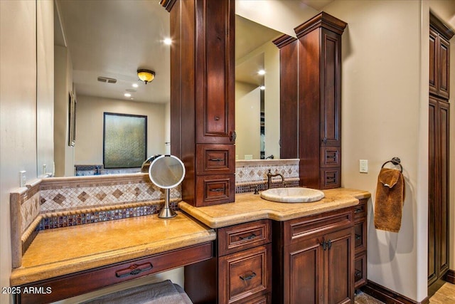 bathroom with visible vents, tasteful backsplash, and vanity