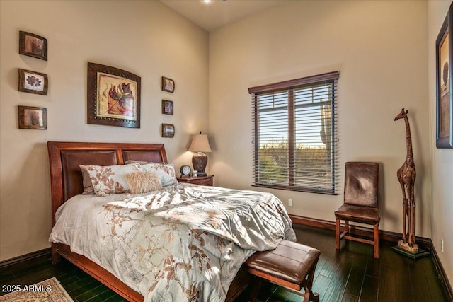 bedroom with baseboards and dark wood-style flooring