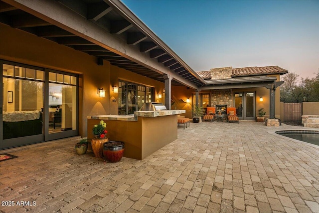 view of patio with area for grilling, a fenced in pool, french doors, and fence