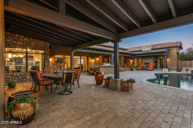 view of patio / terrace featuring an outdoor pool, outdoor dining area, area for grilling, and outdoor dry bar