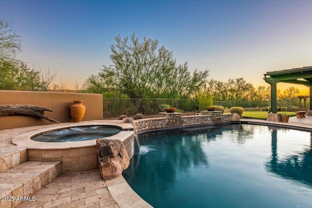 view of swimming pool with an in ground hot tub, fence, and a fenced in pool