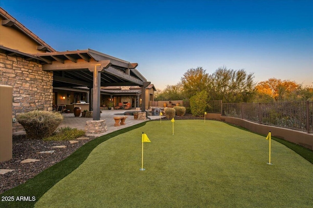 yard at dusk featuring a patio and a fenced backyard